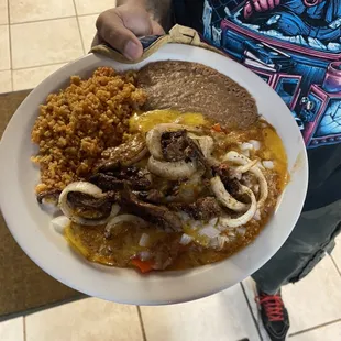 Cheese enchilada plate with beef fajitas on top a customer special request