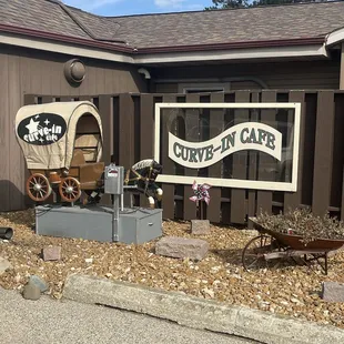 a covered wagon in front of a building