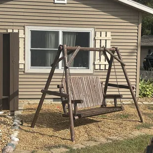 a swing set in front of a house