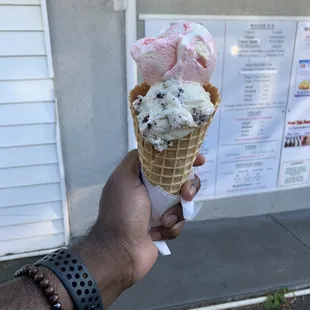 Strawberry Cheesecake and Cookie n Cream on a waffle cone