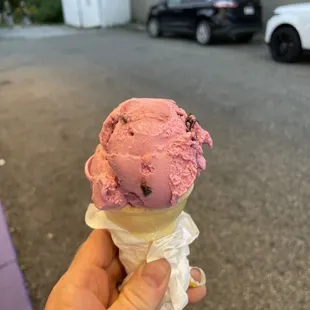 a hand holding an ice cream cone