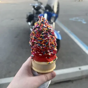 Cone with cherry dip and rainbow sprinkles