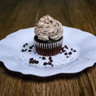 a chocolate cupcake on a white plate