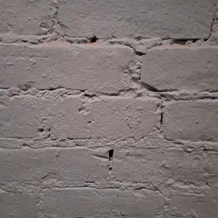 a brick wall with a hole in it