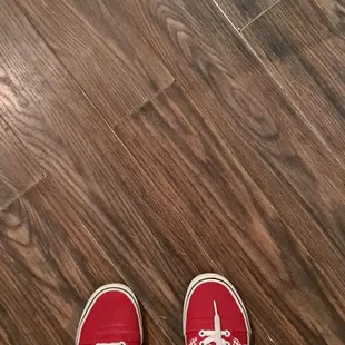 a person standing on a hardwood floor