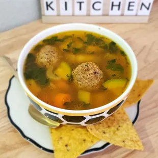 a bowl of soup with tortillas