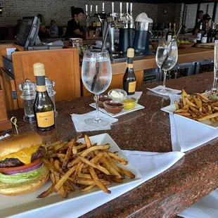 Burger and fries with cheddar cheese.