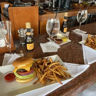 a burger and french fries on a table