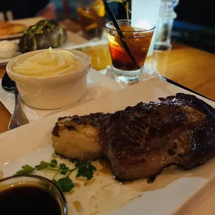 a plate of steak and mashed potatoes