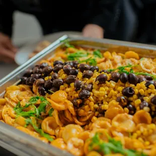 Orecchiette Pasta, Crushed Tomato-Garlic Cream Sauce, Romano Cheese, Kalamata Olive, Corn, Orange Zest