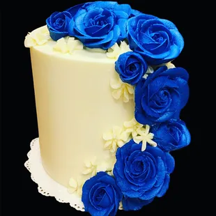 a white cake with blue roses