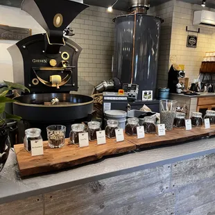 a coffee grinder and various jars of coffee
