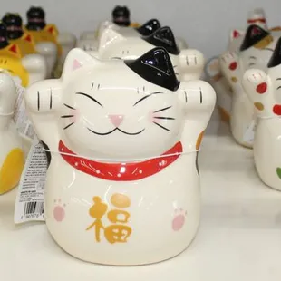 a row of ceramic mane cats