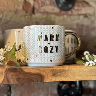 a coffee mug with the words warm cozy on it