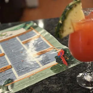 a drink and menu on a table