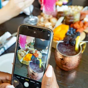 a person taking a picture of a meal
