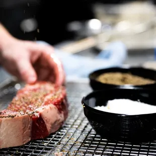 a person preparing a steak