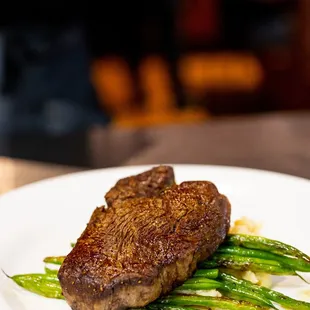 a plate of steak and asparagus