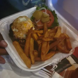Stuffed burger with egg on top.