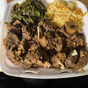 Large curry goat with cabbage,   greens, and rice and peas..