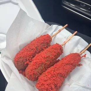 Korean corn dog with half meat and half cheese covered with hot Cheetos