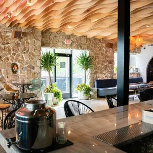 the interior of a restaurant with stone walls