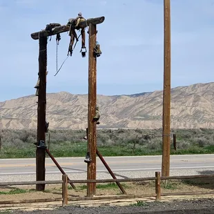 Saddle and cowboy boots hangin on the road sign