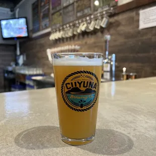 a glass of beer on a bar