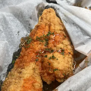 two pieces of chicken in a basket