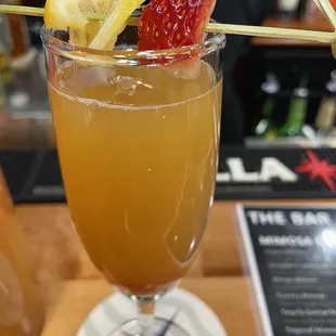 a drink with strawberries and lemons
