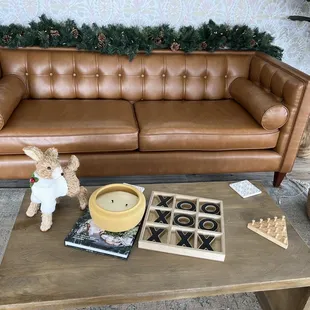 a brown leather couch and coffee table