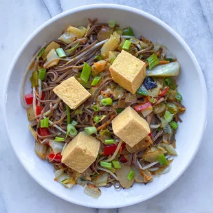 Veggie stirfry served over soba noodles with tofu