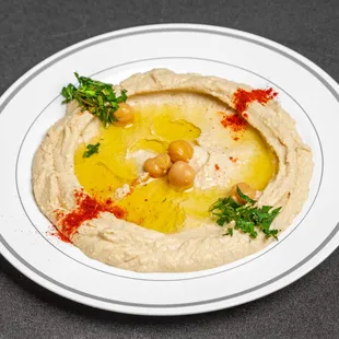 a plate of hummus and olives