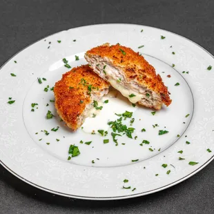 two pieces of chicken cut in half on a plate