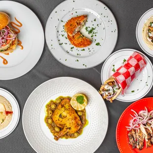 a variety of plates of food on a table