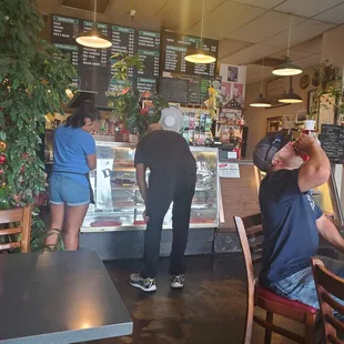 Lots of beautiful plants and the young lady on the left helping a customer.