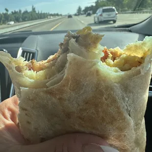 Sausage and bacon potatoes cheese and egg burrito