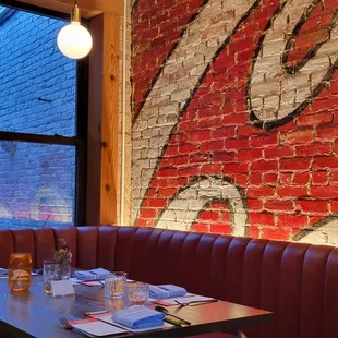 Colourful murals and warm brick interior