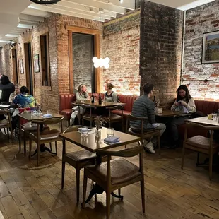 people sitting at tables in a restaurant