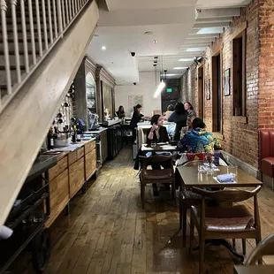 people sitting at tables in a restaurant