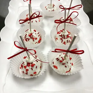a white platter with red and white sprinkles