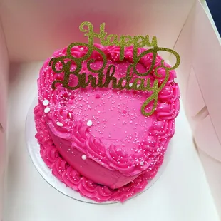 a pink birthday cake