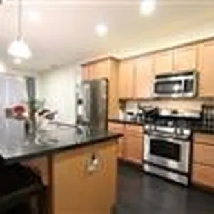 Party kitchen! Contemporary granite and stainless appliances.