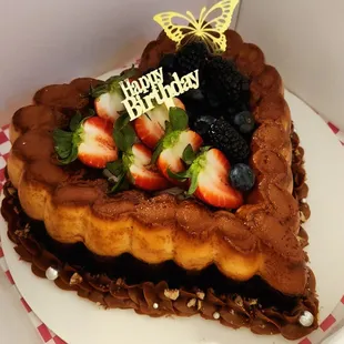 Chocoflan Cake, is a chocolate cake on bottom and delicious homemade Flan on top, decorated with Dulce de Leche and fresh berries