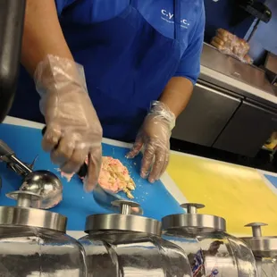 Preparing my single cheesecake scoop by mixing in the toppings, cold stone style.