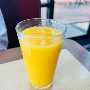 Glass of orange juice; it was not cold at all and the server did not provide a straw