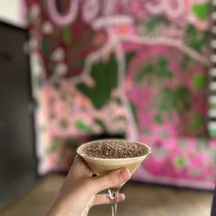 a woman holding a glass of coffee