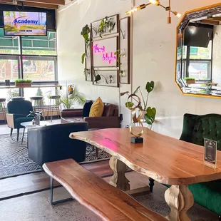 a dining table with benches and a mirror