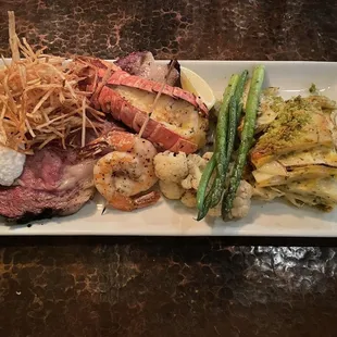 NYE special: 16-ounce oak-smoked prime rib, lobster tail, Gulf shrimp skewer, asparagus, green beans, scalloped potatoes