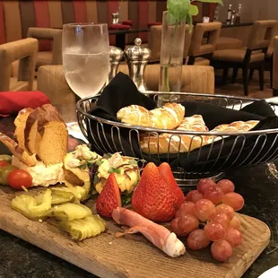 a platter of food and a glass of wine